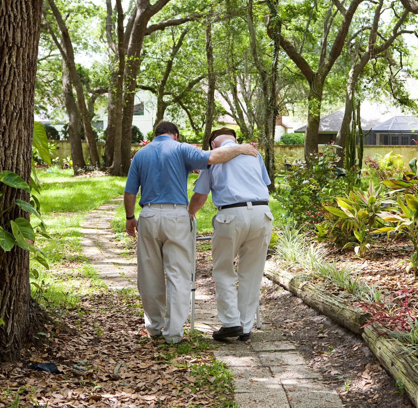 Caregiver helping an older adult prevent falls and move safely at home in NYC